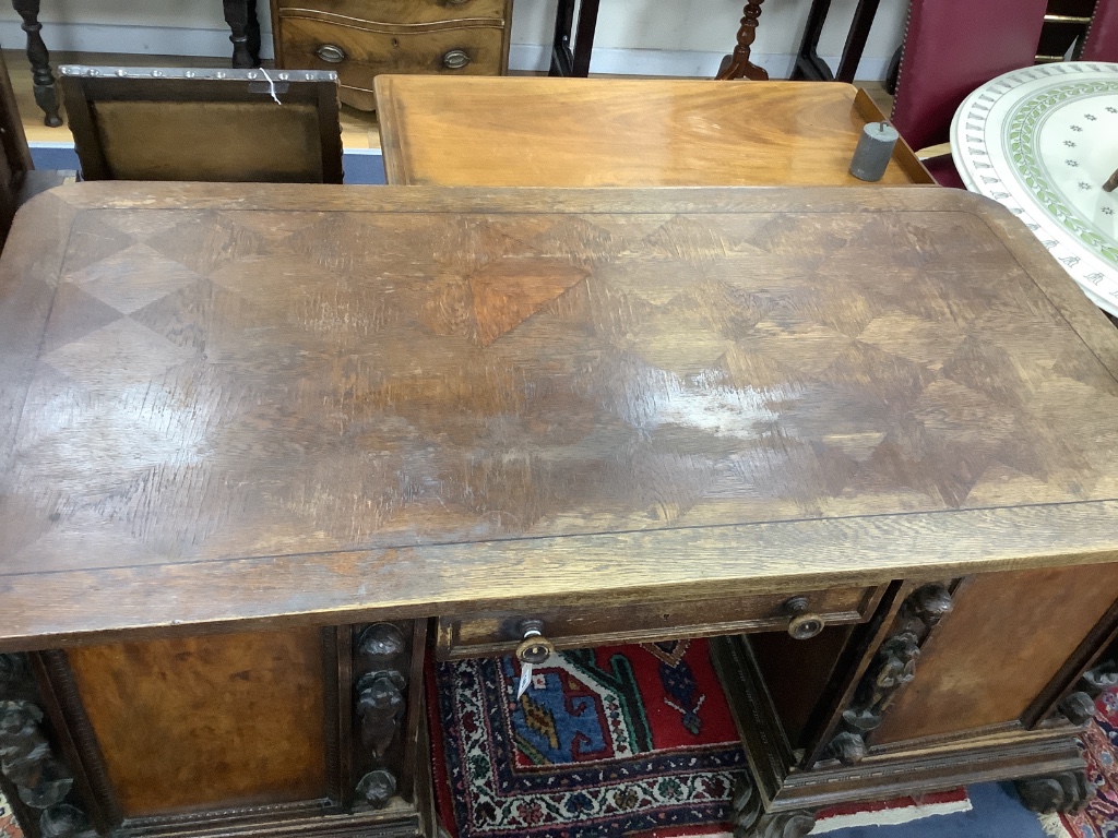 A large late 19th century oak and walnut kneehole desk, width 180cm depth 91cm height 78cm